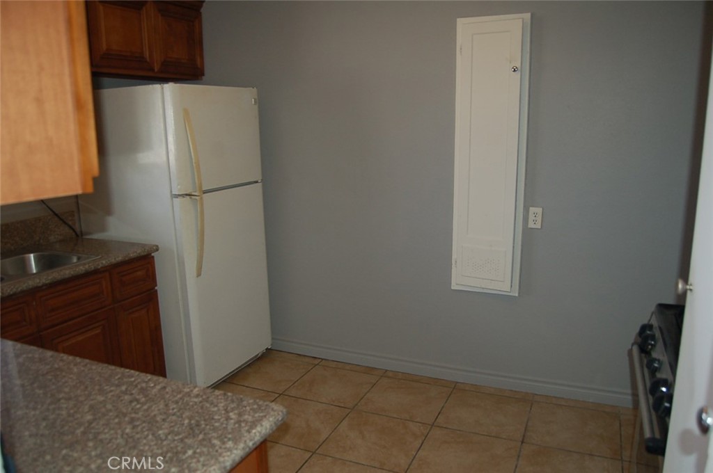 422 West Palm Street, Unit 424 1/2D Compton, CA 90220 - Photo 13 of 17 a view of a kitchen with refrigerator and cabinet