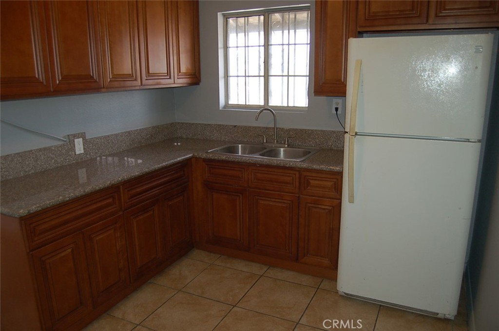 422 West Palm Street, Unit 424 1/2D Compton, CA 90220 - Photo 14 of 17 a kitchen with stainless steel appliances granite countertop a refrigerator and a sink