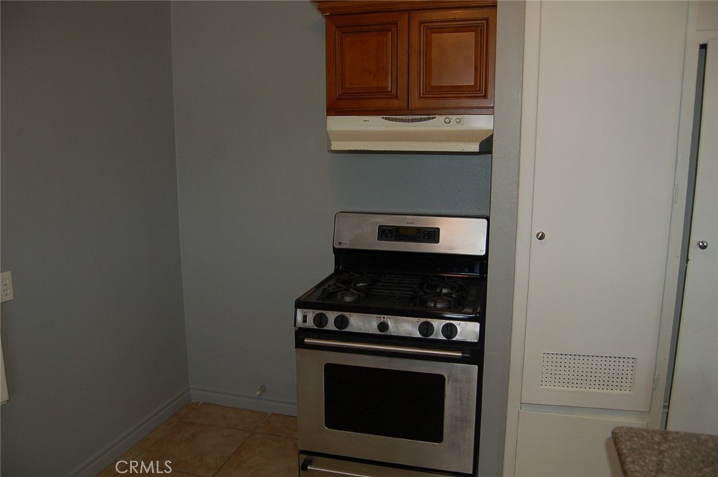 422 West Palm Street, Unit 424 1/2D Compton, CA 90220 - Photo 15 of 17 a stove top oven sitting inside of a kitchen