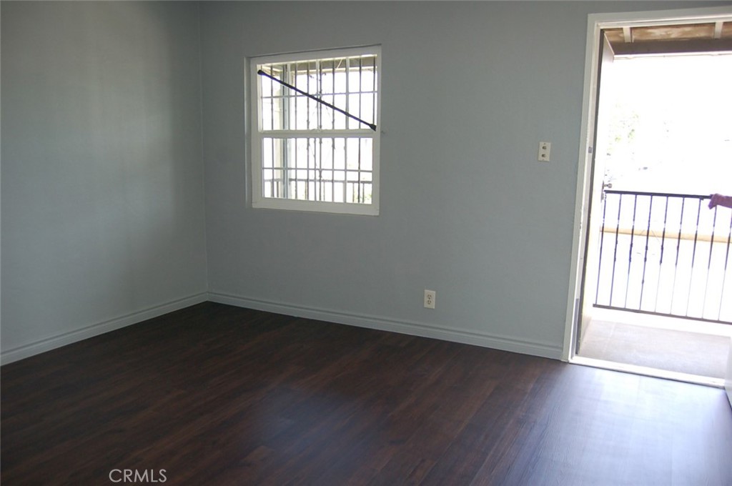 422 West Palm Street, Unit 424 1/2D Compton, CA 90220 - Photo 6 of 17 an empty room with wooden floor and windows
