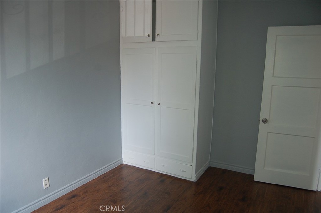 422 West Palm Street, Unit 424 1/2D Compton, CA 90220 - Photo 8 of 17 an empty room with wooden floor