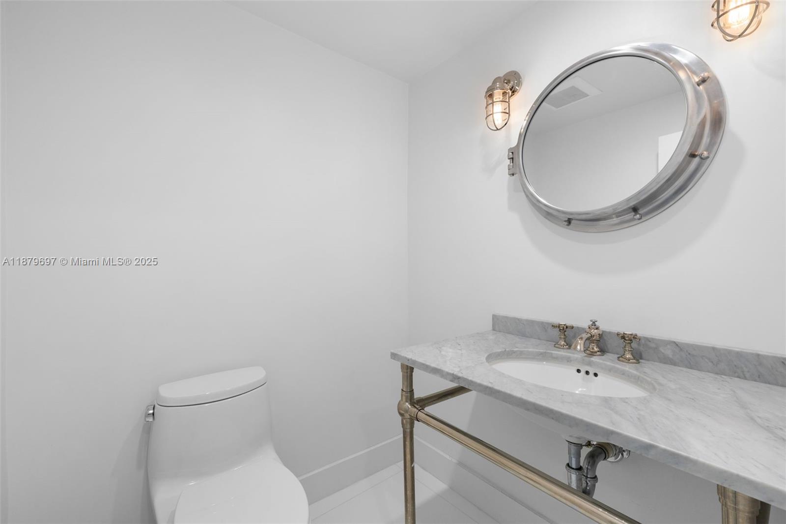 100 Lincoln Road, Unit 1523/1525 Miami Beach, FL 33139 - Photo 13 of 35 a bathroom with a granite countertop toilet a sink and mirror