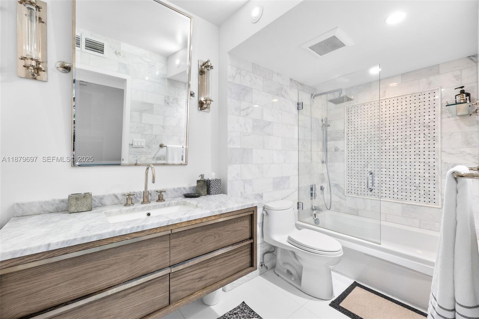 100 Lincoln Road, Unit 1523/1525 Miami Beach, FL 33139 - Photo 16 of 25 a bathroom with a sink a toilet and a large mirror