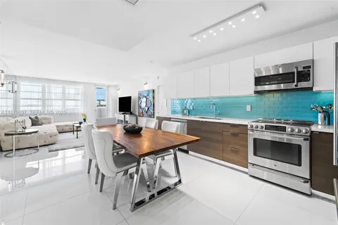 a kitchen with stainless steel appliances kitchen island granite countertop a stove a sink and a microwave