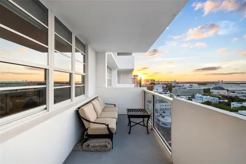 a view of a chairs and table in the balcony