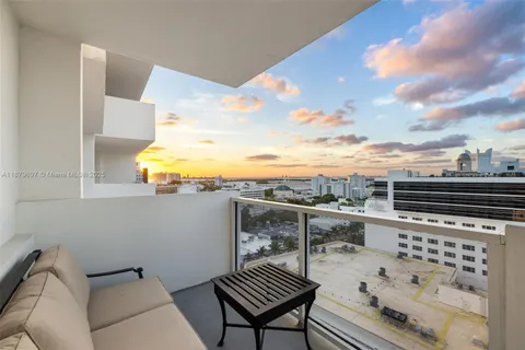 a view of roof deck with two chair and a potted plant