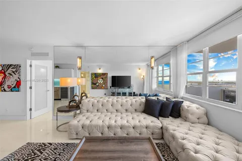 a living room with furniture large window and couch