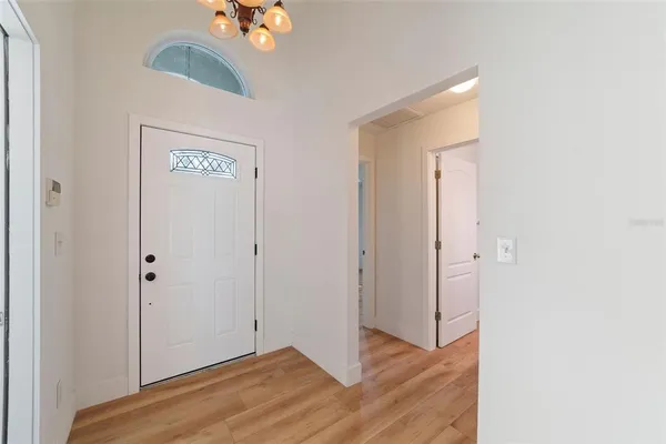 a view of an entryway with wooden floor