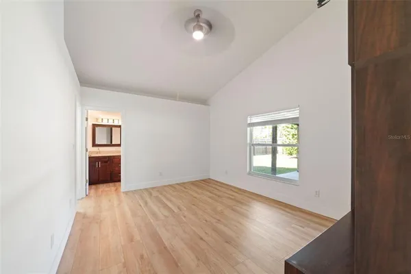 an empty room with windows and closet
