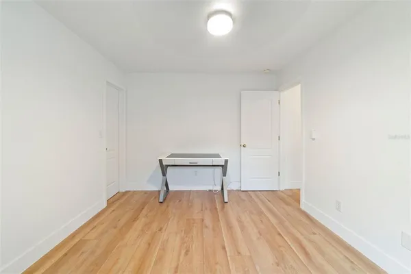 a view of a room with wooden floor and bench