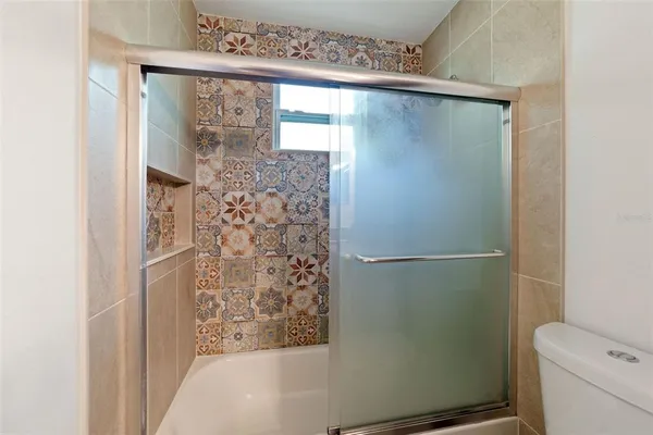 a bathroom with a bathtub and shower