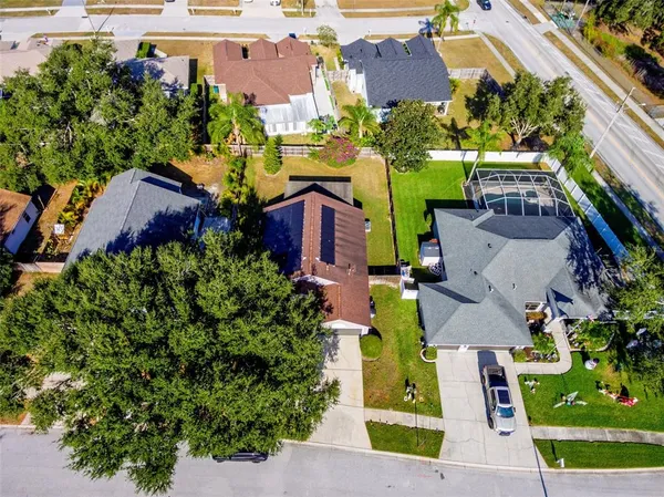 an aerial view of multiple houses with a yard