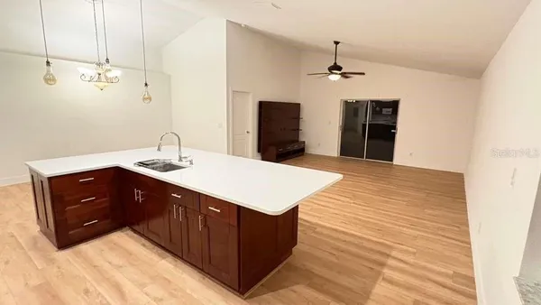 a kitchen with a sink vanity and a granite counter top