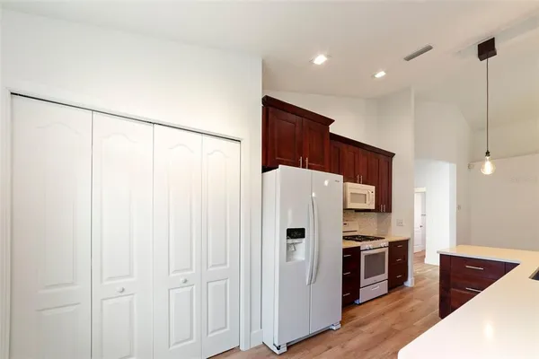 a kitchen with stainless steel appliances a refrigerator and a stove top oven