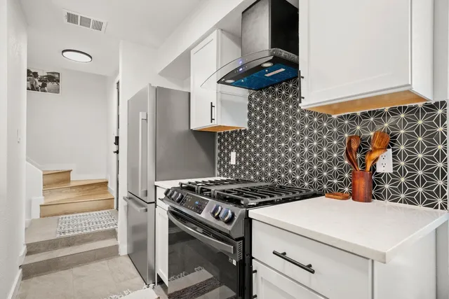 a kitchen with stainless steel appliances a stove and a refrigerator