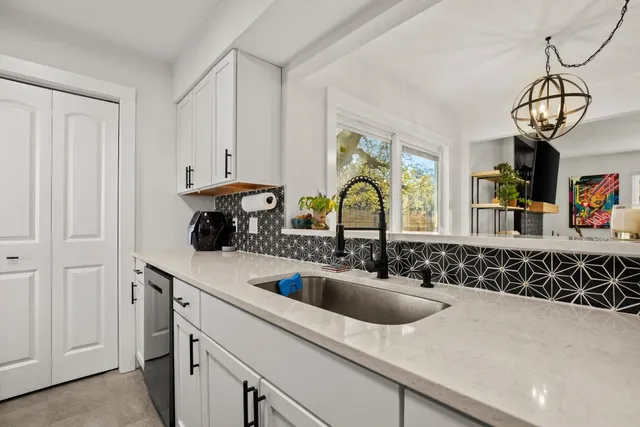 a kitchen with a sink and cabinets
