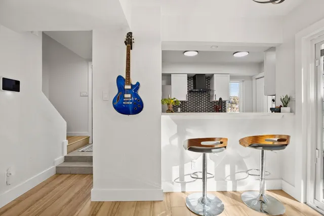 a kitchen with stainless steel appliances kitchen island granite countertop a table and chairs in it