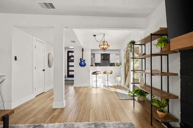 a living room with furniture and wooden floor