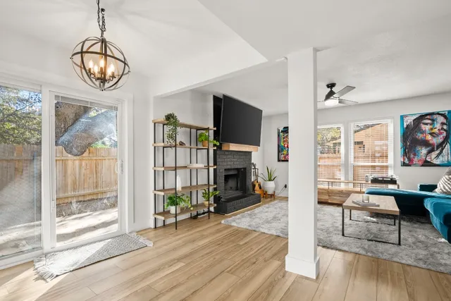 a view of a livingroom with wooden floor and a large window