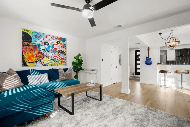 a living room with furniture and wooden floor