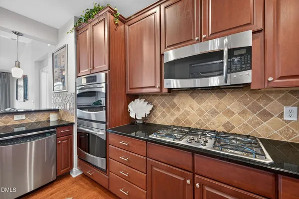 a kitchen with wooden cabinets and a stove top oven