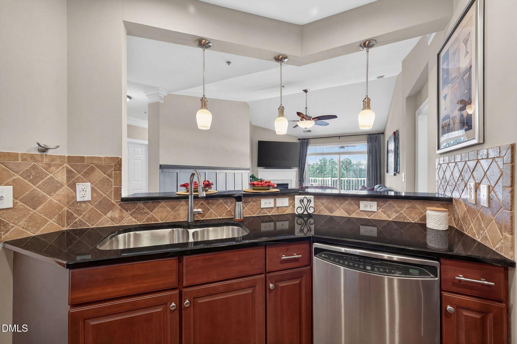 10511 Rosegate Court, Unit 305 Raleigh, NC 27617 - Photo 13 of 48 a kitchen with stainless steel appliances granite countertop a sink and a microwave