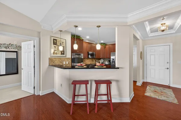 a kitchen with stainless steel appliances granite countertop a refrigerator and a stove top oven