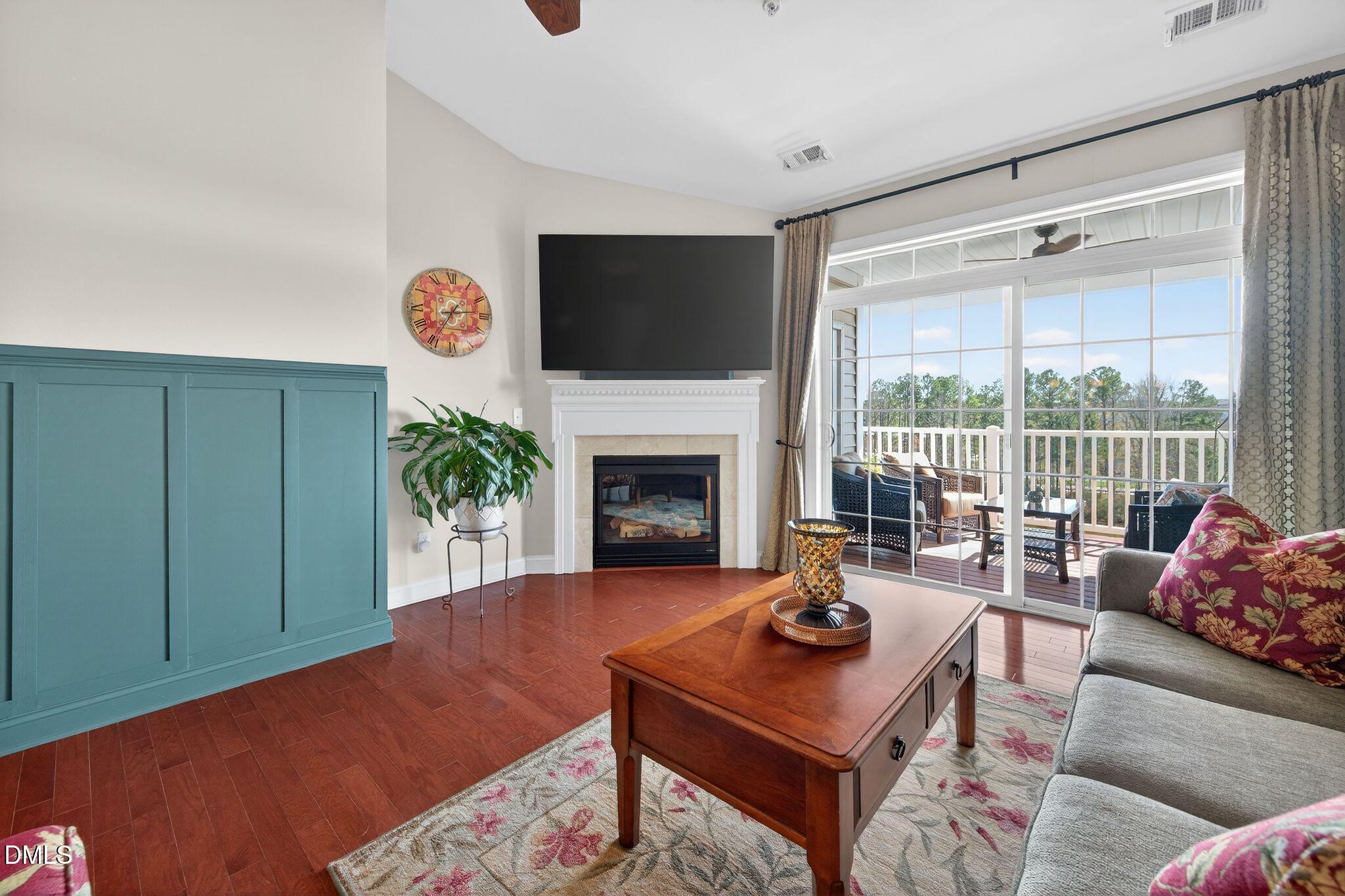 10511 Rosegate Court, Unit 305 Raleigh, NC 27617 - Photo 20 of 48 a living room with furniture a flat screen tv and a fireplace