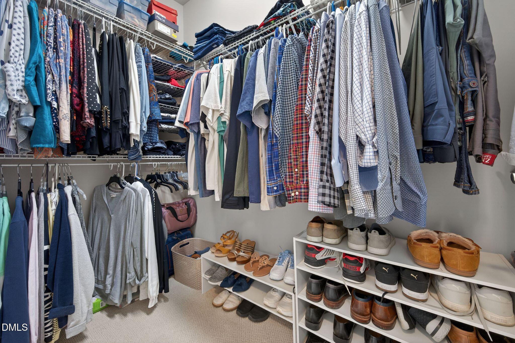 10511 Rosegate Court, Unit 305 Raleigh, NC 27617 - Photo 32 of 48 a view of walk in closet with clothes and shoes
