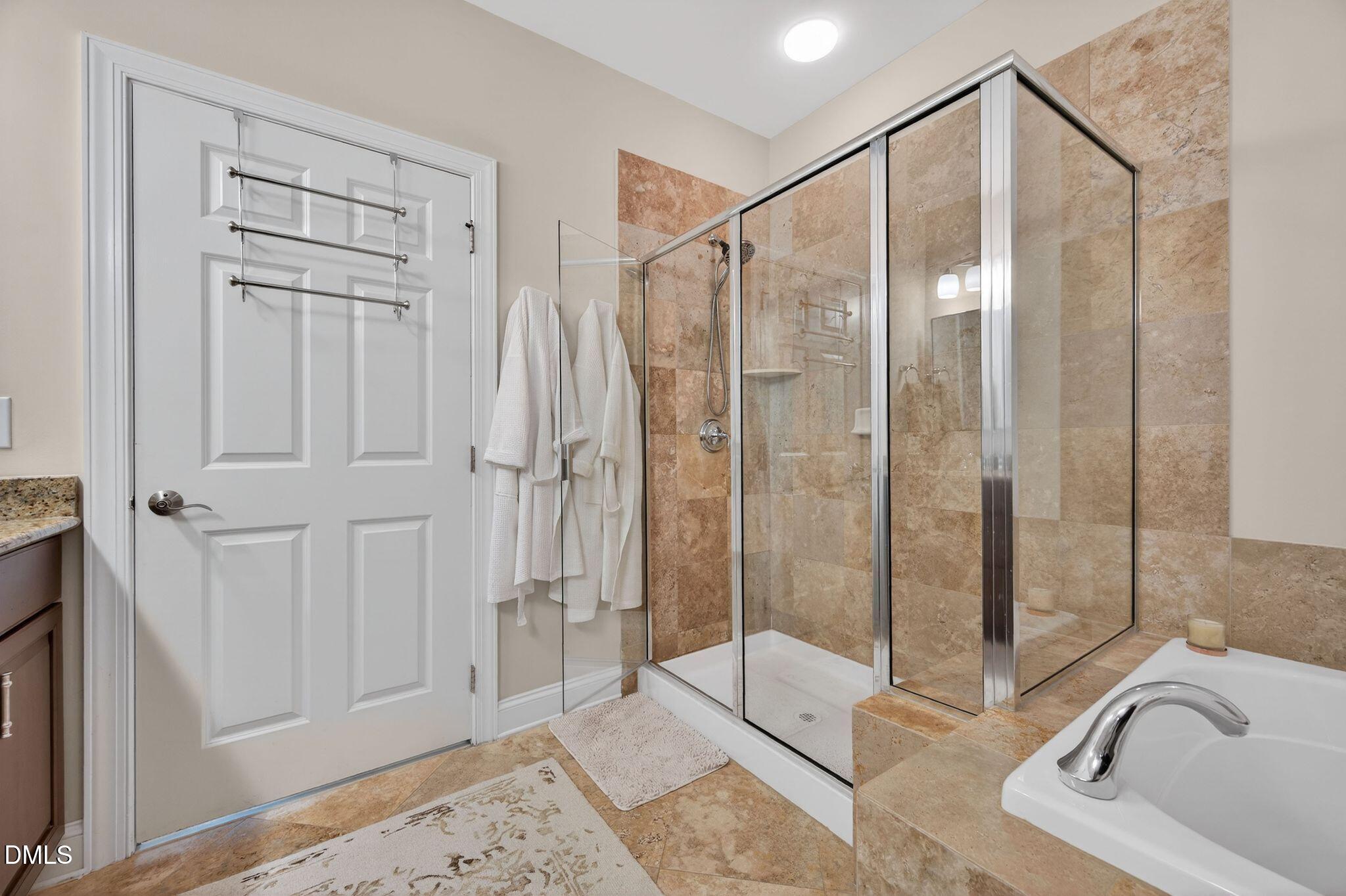 10511 Rosegate Court, Unit 305 Raleigh, NC 27617 - Photo 35 of 48 a bathroom with a bathtub and a shower