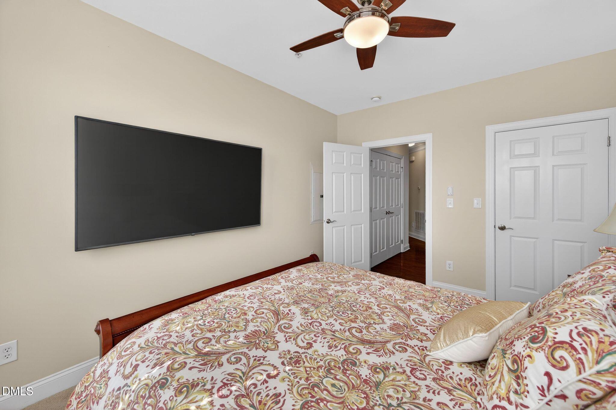 10511 Rosegate Court, Unit 305 Raleigh, NC 27617 - Photo 38 of 48 a bedroom with a bed and a flat screen tv