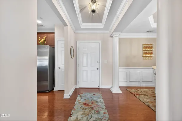 a view of hallway with livingroom and wooden floor