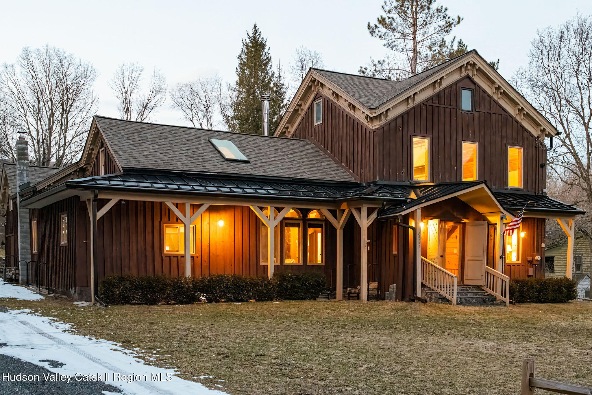 a view of a house with large windows and a ceiling fan
