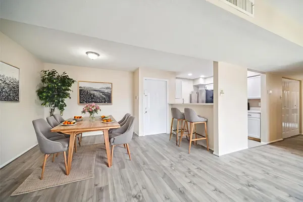 a dining room with furniture and wooden floor