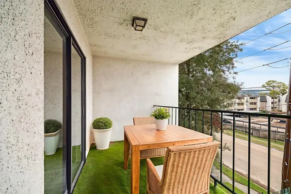 a balcony view with an outdoor seating
