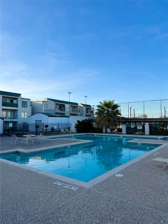 a view of a swimming pool and a yard