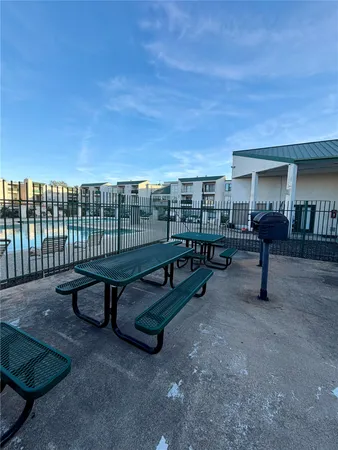 a view of a patio with a table and chairs