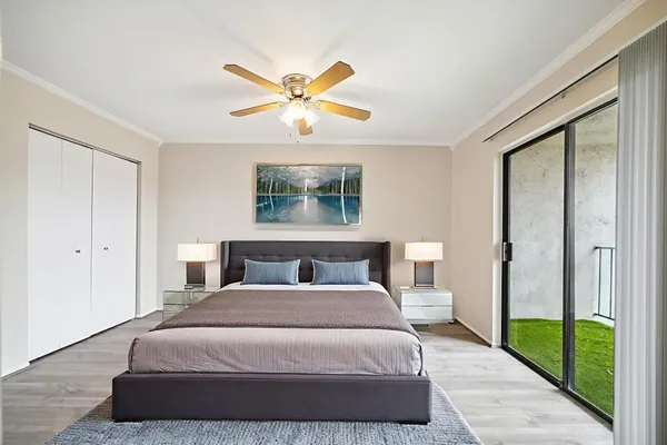 a bedroom with a bed and a chandelier