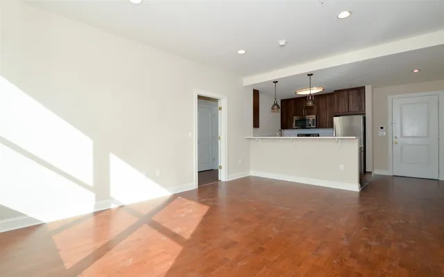 a view of a kitchen with a sink and a refrigerator