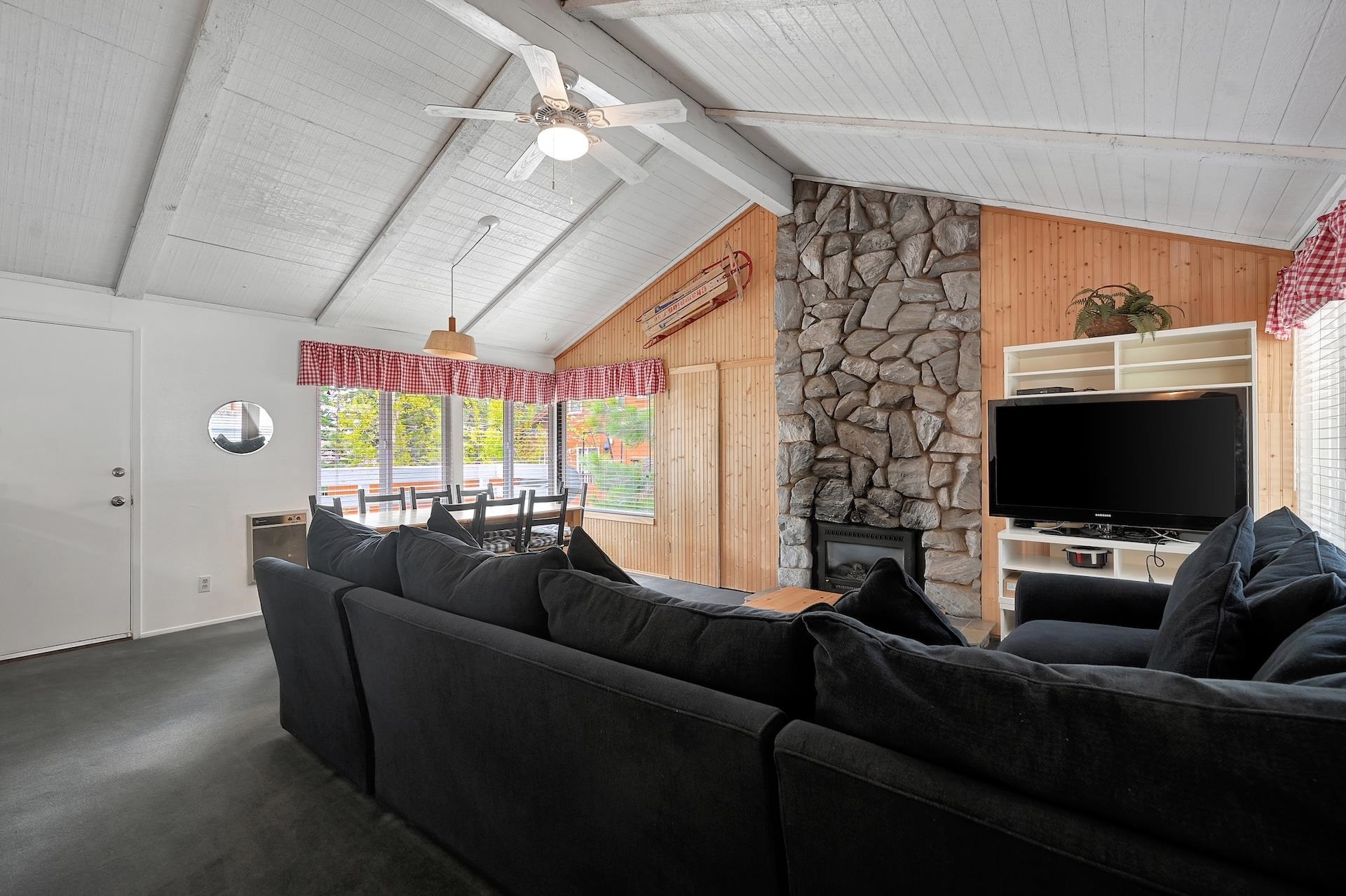 2 Snowridge Lane Mammoth Lakes, CA 93546 - Photo 4 of 25 a living room with furniture a flat screen tv and a large window