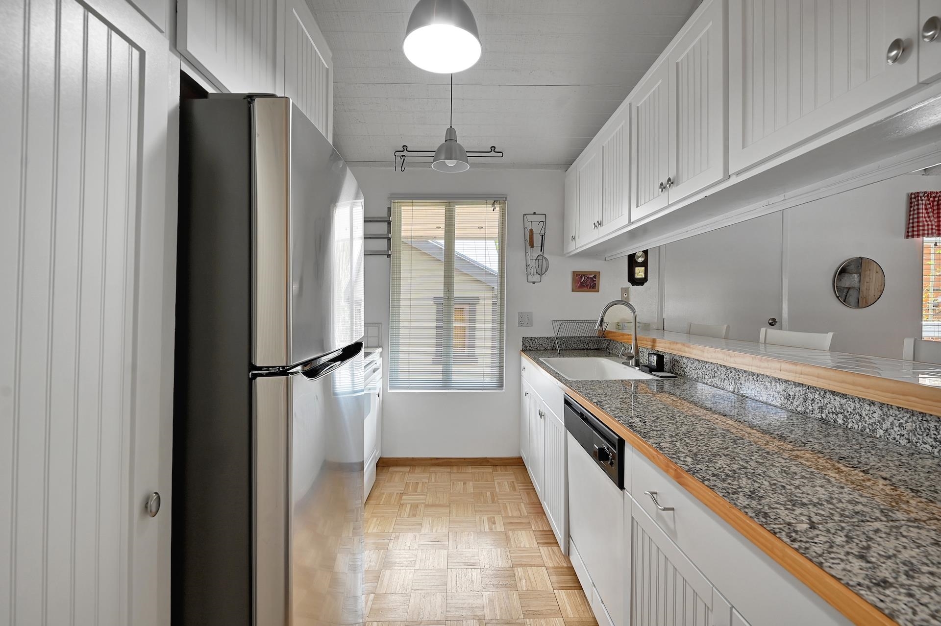 2 Snowridge Lane Mammoth Lakes, CA 93546 - Photo 9 of 25 a kitchen with granite countertop a refrigerator and a sink