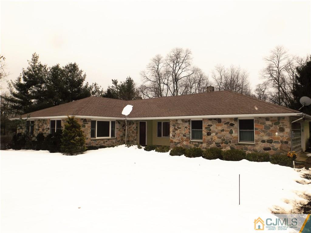 218 Docks Corner Road Dayton, NJ 08810 - Photo 1 of 21 a view of house with a yard covered in snow