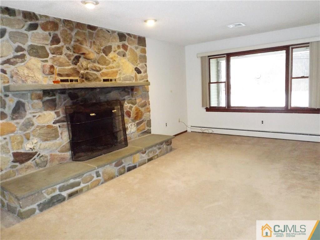 218 Docks Corner Road Dayton, NJ 08810 - Photo 12 of 21 a view of an empty room with a fireplace and a window