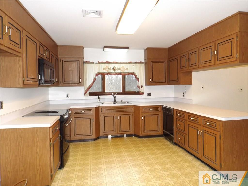 218 Docks Corner Road Dayton, NJ 08810 - Photo 8 of 21 a kitchen with stainless steel appliances granite countertop a sink stove and cabinets