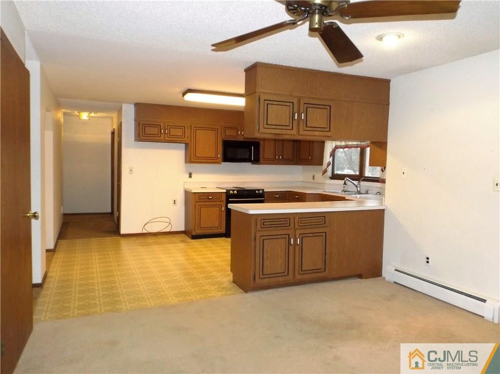 218 Docks Corner Road Dayton, NJ 08810 - Photo 10 of 21 a kitchen with stainless steel appliances granite countertop a stove a sink and a refrigerator