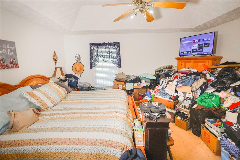 760 Breedlove Road Ball Ground, GA 30107 - Photo 12 of 18 a bed room with a bed and a chandelier