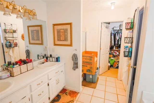 a bathroom with a sink mirror and shower