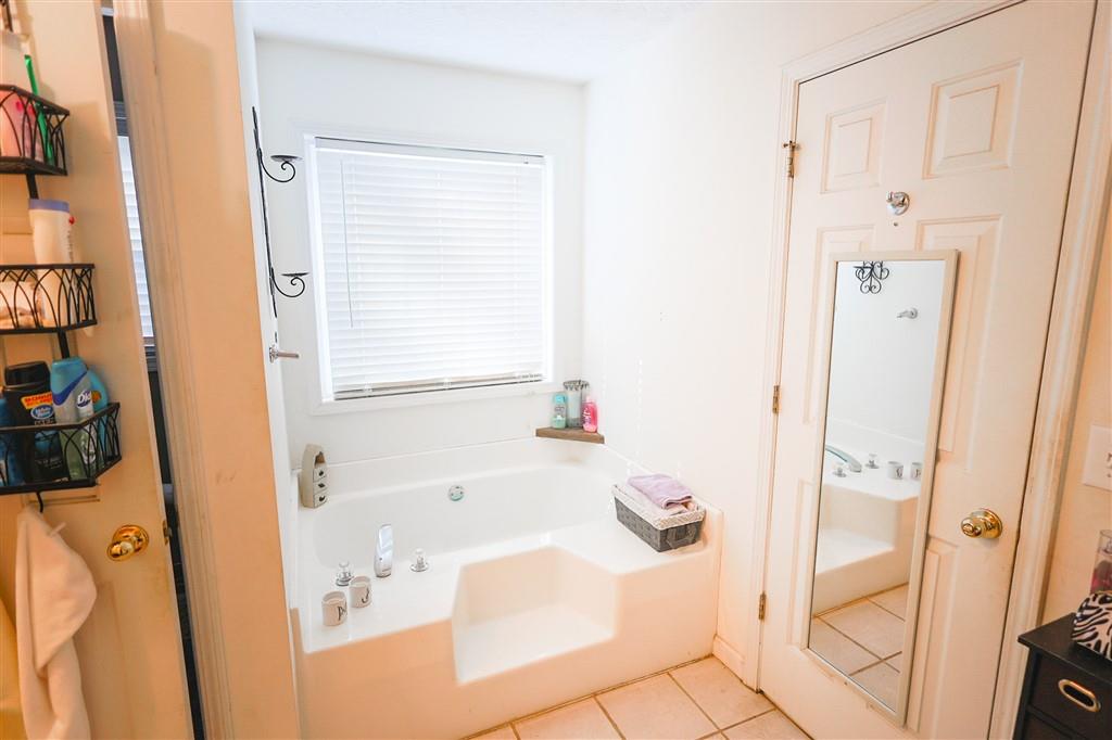 760 Breedlove Road Ball Ground, GA 30107 - Photo 14 of 18 a bathroom with a bathtub and a shower