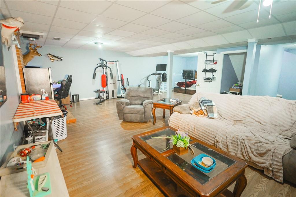 760 Breedlove Road Ball Ground, GA 30107 - Photo 18 of 18 a living room with furniture and a wooden floor
