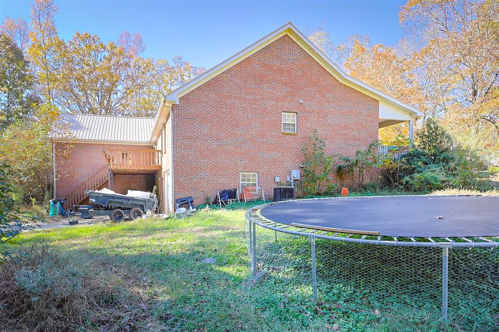 760 Breedlove Road Ball Ground, GA 30107 - Photo 2 of 18 a view of an house with backyard and a tree